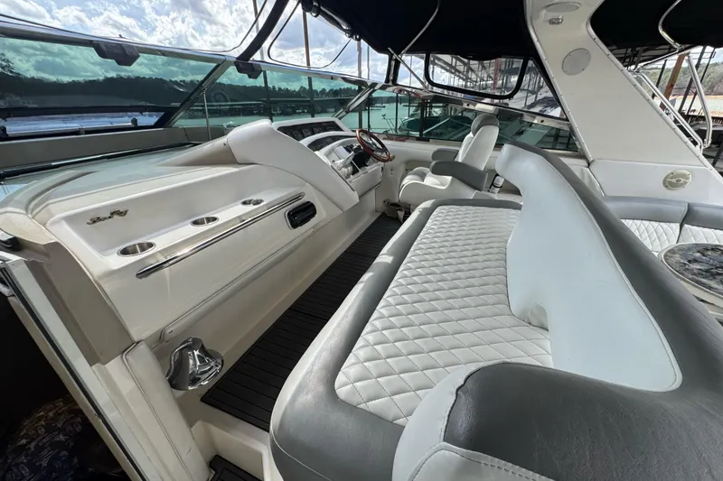 Slide: The Image of 1996 Sea Ray 500 Sedan Bridge interior with luxurious seating and helm. - 12
