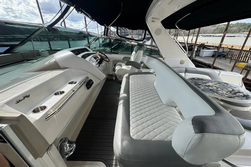 Slide: The Image of Luxurious interior of 1996 Sea Ray 500 Sedan Bridge yacht with plush seating and helm. - 13