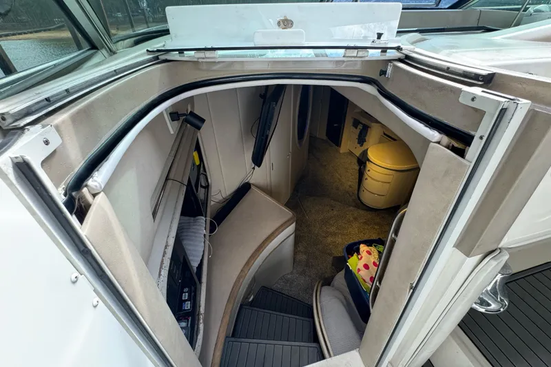 Slide: The Image of 1996 Sea Ray 500 Sedan Bridge interior cabin with stairs and seating area. - 15