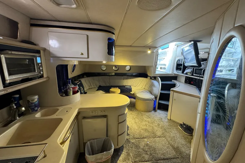Slide: The Image of Interior of 1996 Sea Ray 500 Sedan Bridge yacht with kitchen and seating area. - 18