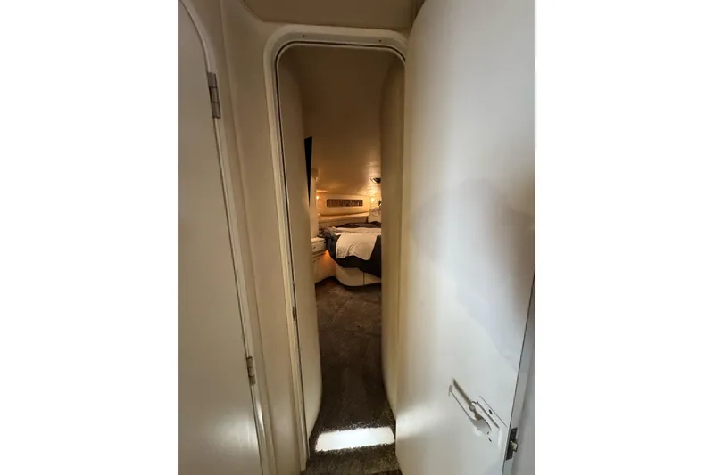 Slide: The Image of Interior view of 1996 Sea Ray 500 Sedan Bridge cabin, featuring cozy bedroom. - 23