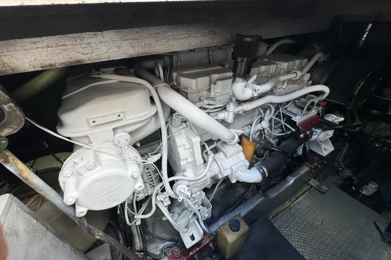Slide: The Image of Engine compartment of a 1996 Sea Ray 500 Sedan Bridge, showcasing detailed mechanical components. - 33