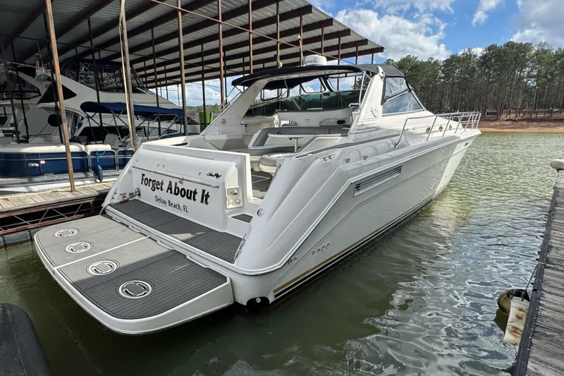 Slide: The Image of 1996 Sea Ray 500 Sedan Bridge docked, featuring spacious deck and sleek design. - 4