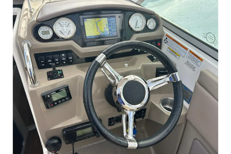 Slide: The Image of 2017 Regal 28 Express boat dashboard with steering wheel and navigation controls. - 11