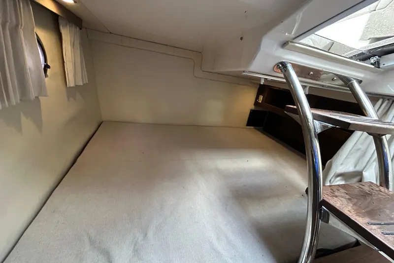 Slide: The Image of 2017 Regal 28 Express cabin interior with ladder and window curtains. - 15