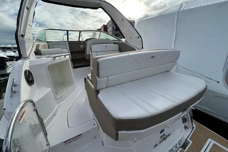 Slide: The Image of 2017 Regal 28 Express boat interior with white seating and open deck view. - 3