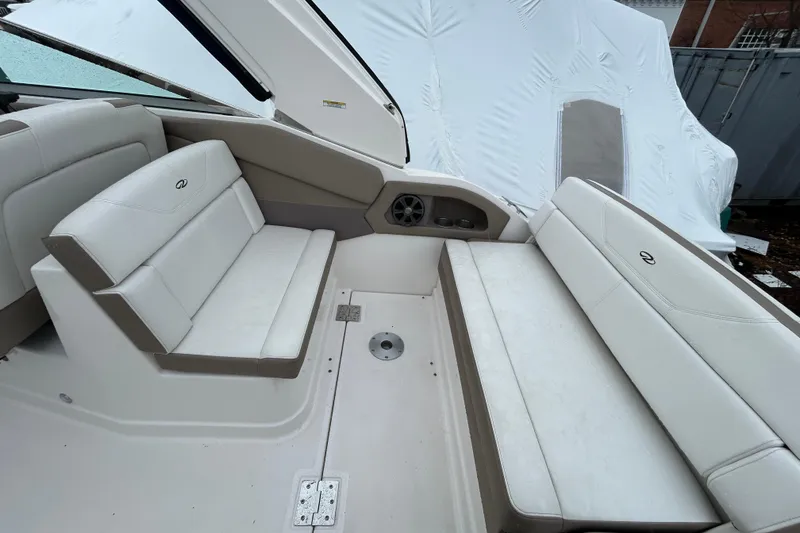 Slide: The Image of 2017 Regal 28 Express boat interior with white seating and speaker. - 6