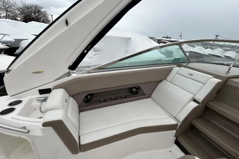 Slide: The Image of 2017 Regal 28 Express boat interior with beige seating and cup holders. - 9