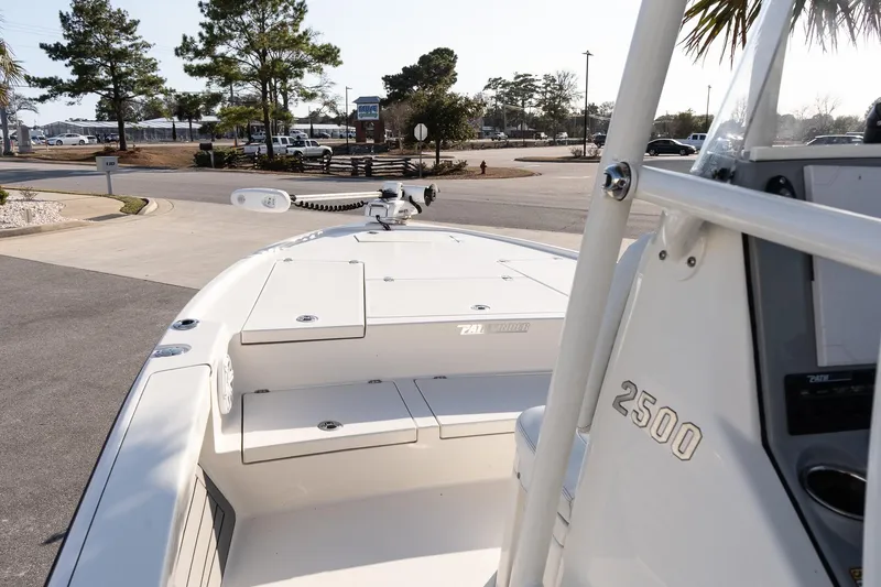 Slide: The Image of 2024 Pathfinder 2500 Hybrid boat, docked with clear view of deck and console. - 11