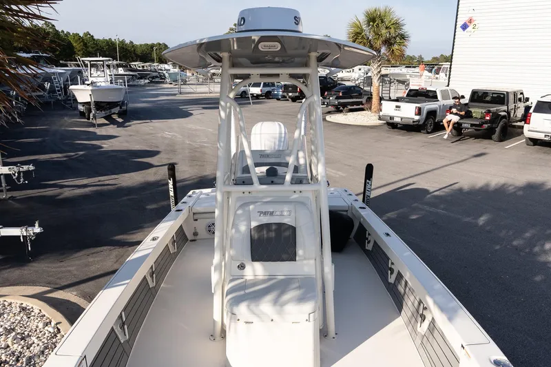Slide: The Image of 2024 Pathfinder 2500 Hybrid boat in a marina, surrounded by parked vehicles and palm trees. - 13
