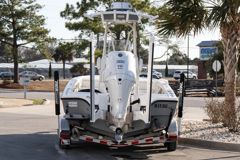 Slide: The Image of 2024 Pathfinder 2500 Hybrid boat on trailer, parked outdoors near palm trees. - 4
