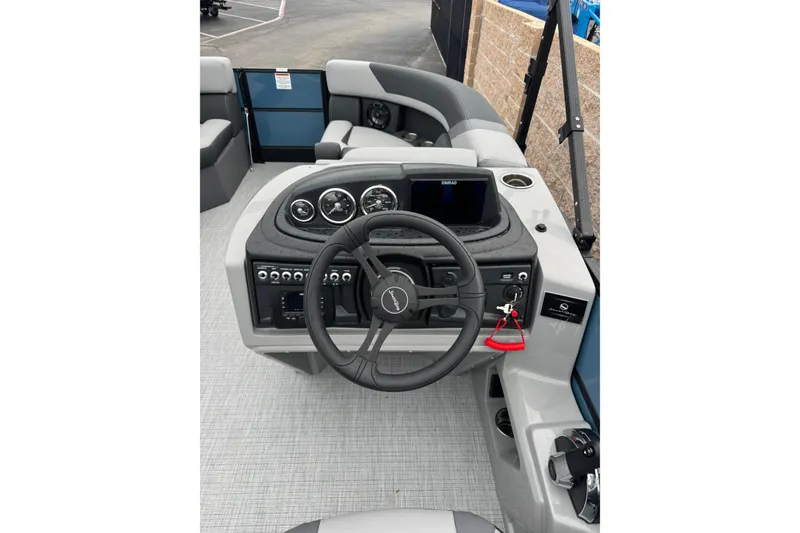Slide: The Image of 2026 South Bay S222E boat dashboard with steering wheel and control panel. - 10