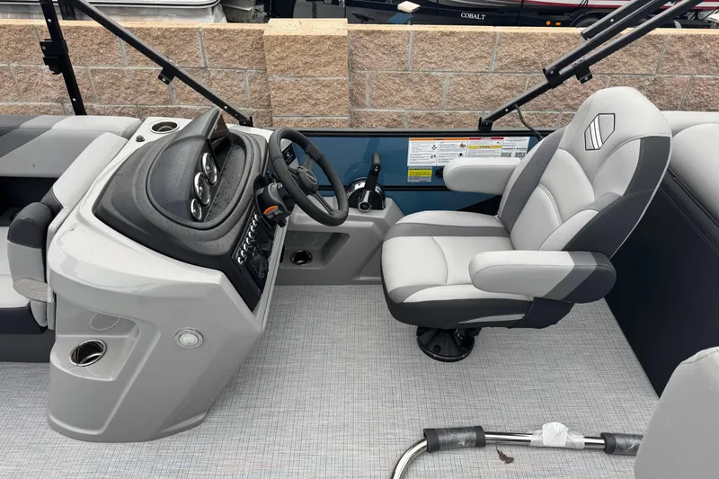 Slide: The Image of 2026 South Bay S222E boat interior with steering console and captain's chair. - 14