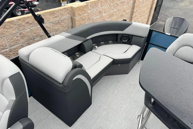 Slide: The Image of 2026 South Bay S222E pontoon boat interior with gray seating and cup holders. - 15