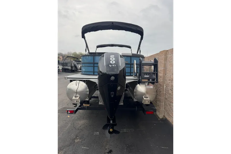 Slide: The Image of 2026 South Bay S222E pontoon boat with 200 V6 engine, parked outdoors. - 4