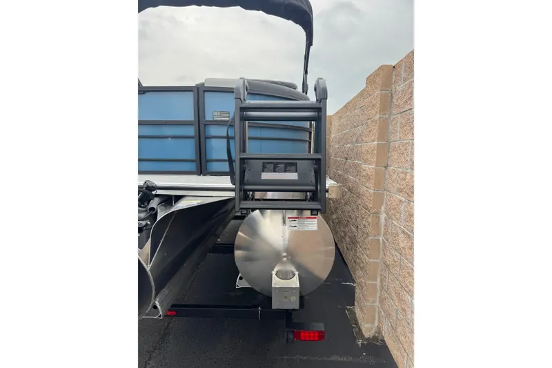 Slide: The Image of 2026 South Bay S222E pontoon boat rear view, parked beside a brick wall. - 5