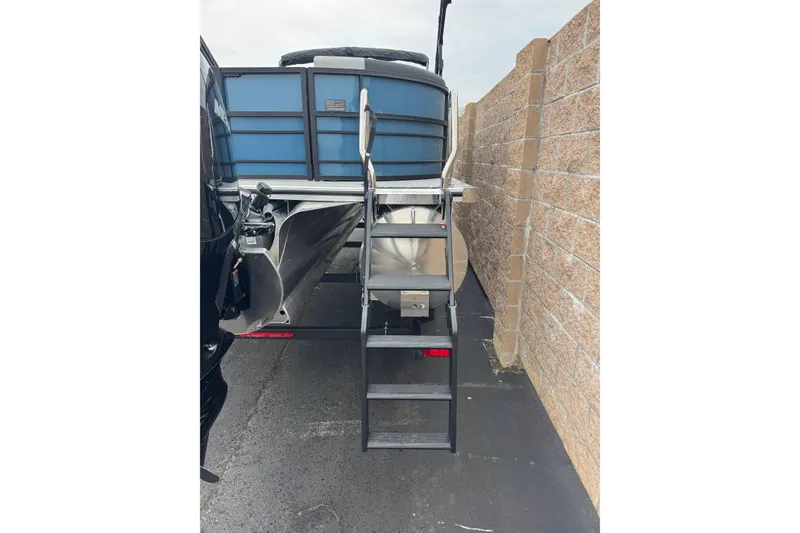 Slide: The Image of 2026 South Bay S222E pontoon boat rear view with ladder and trailer. - 6