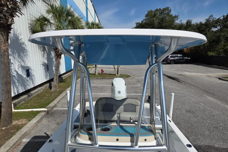 Slide: The Image of 2022 Aquasport 244 Bay boat with T-top in a parking lot. - 12