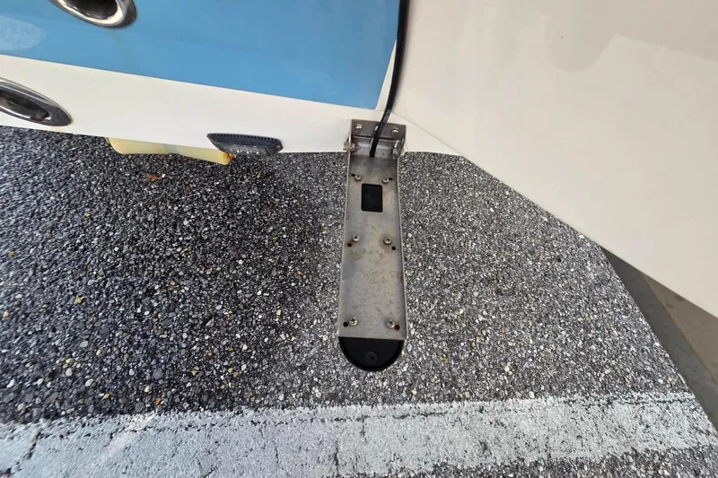Slide: The Image of 2022 Aquasport 244 Bay boat detail showing metal component on textured surface. - 13