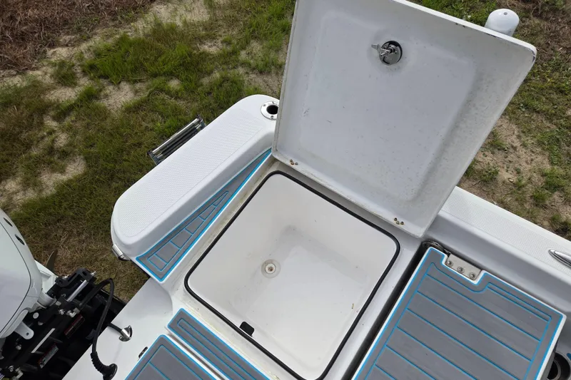 Slide: The Image of Open storage compartment on 2022 Aquasport 244 Bay boat, showing interior details. - 15