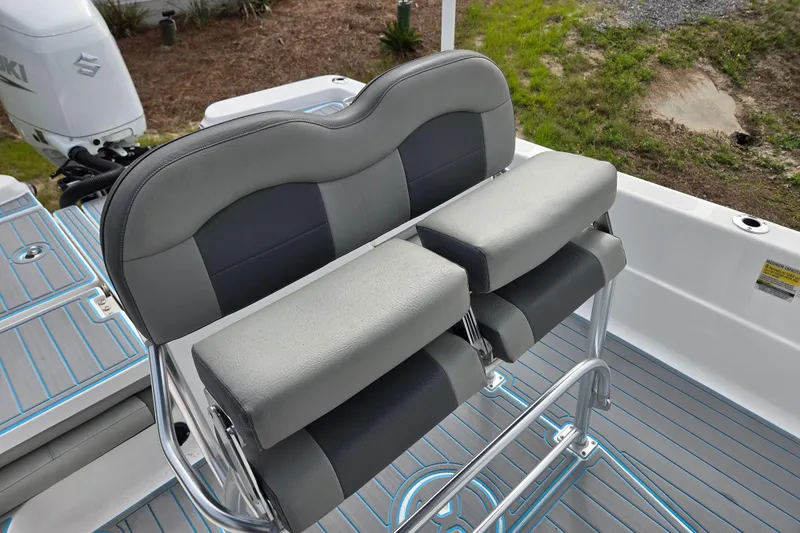 Slide: The Image of 2022 Aquasport 244 Bay boat seating with gray cushions and sleek design. - 17