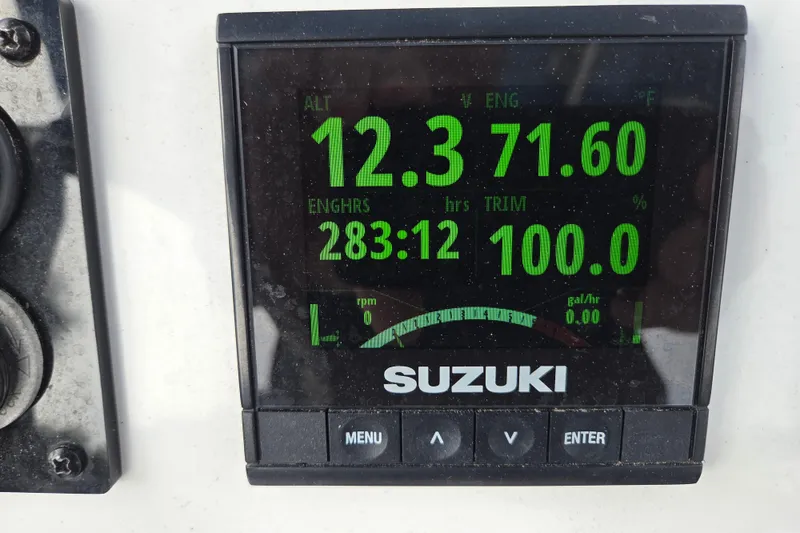 Slide: The Image of Suzuki engine display on 2022 Aquasport 244 Bay showing metrics like voltage and engine hours. - 21