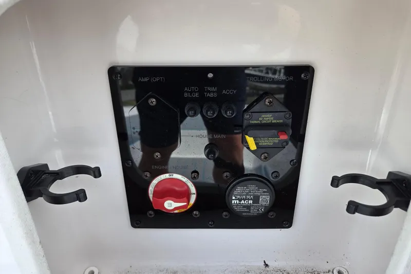 Slide: The Image of Control panel of 2022 Aquasport 244 Bay boat with switches and circuit breaker. - 23