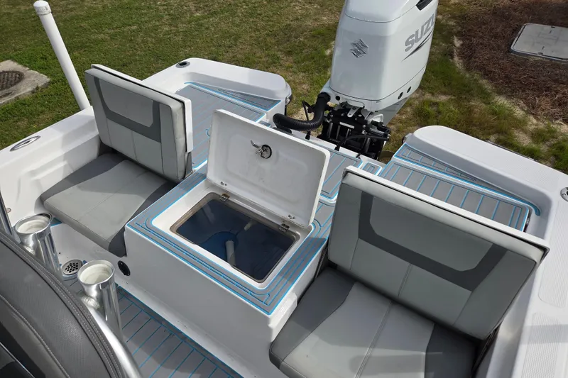 Slide: The Image of 2022 Aquasport 244 Bay boat interior with seating and open storage compartment. - 26