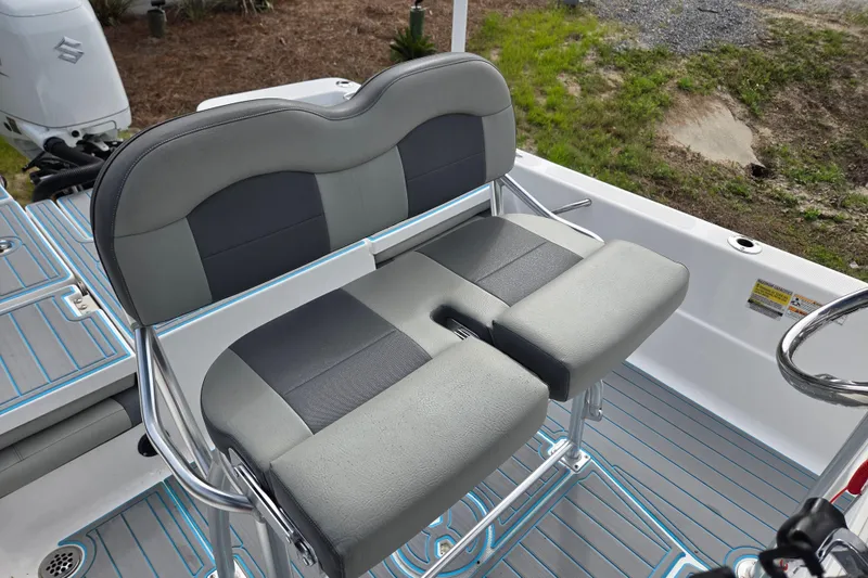 Slide: The Image of 2022 Aquasport 244 Bay boat seating with gray and black cushioned bench. - 28