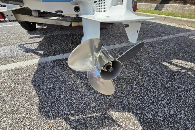 Slide: The Image of 2022 Aquasport 244 Bay boat propeller on a trailer, close-up view. - 6