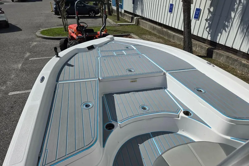 Slide: The Image of 2022 Aquasport 244 Bay boat deck with sleek gray and blue design in parking lot. - 7