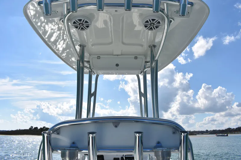 Slide: The Image of 2023 Dorado 25 boat with T-top and speakers against a blue sky. - 17