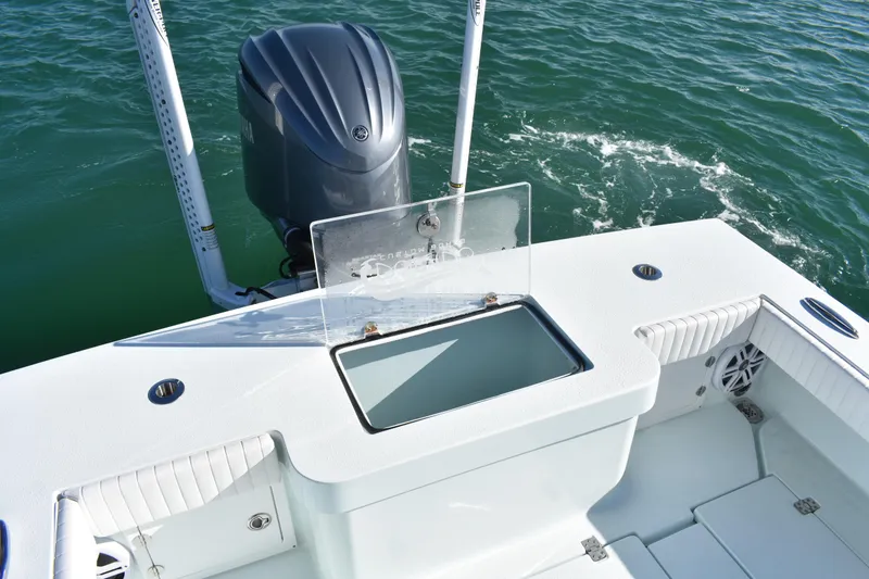 Slide: The Image of 2023 Dorado 25 boat with open storage compartment and outboard motor on water. - 18