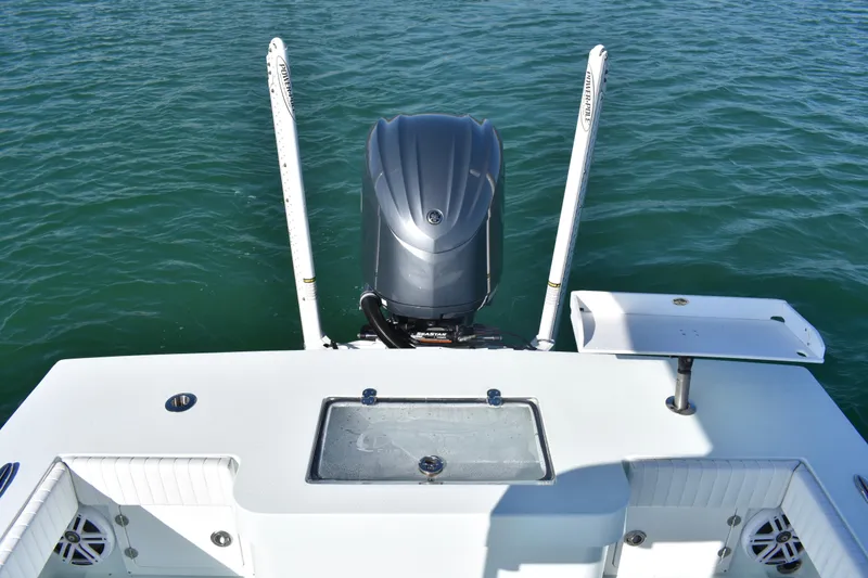 Slide: The Image of 2023 Dorado 25 boat with outboard motor on calm water. - 19