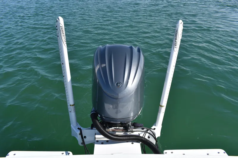 Slide: The Image of 2023 Dorado 25 boat with outboard motor and Power-Pole anchors on water. - 21