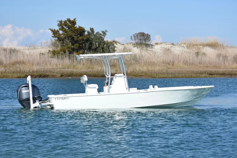 Slide: The Image of 2023 Dorado 25 boat on calm water with Yamaha outboard motor. - 4