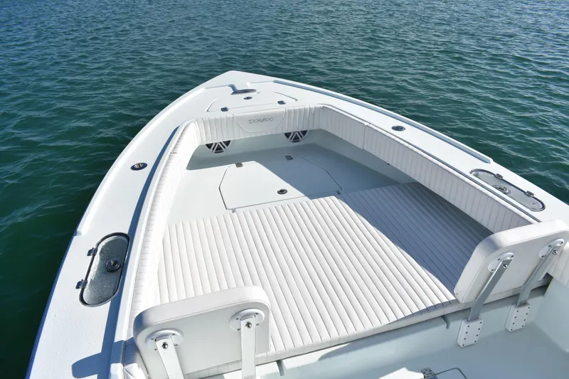 Slide: The Image of 2023 Dorado 25 boat with spacious deck and seating on calm water. - 6