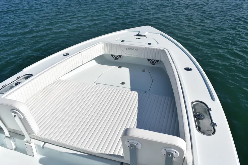 Slide: The Image of 2023 Dorado 25 boat with spacious deck and seating on calm water. - 7
