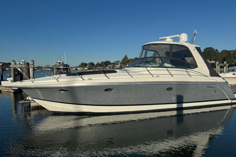 The Image of 2005 Formula 40 Performance Cruiser docked in a marina under clear blue skies. - 0