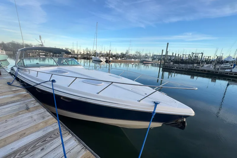 Slide: The Image of 2003 Formula 400 Super Sport boat docked at a marina under a clear blue sky. - 1