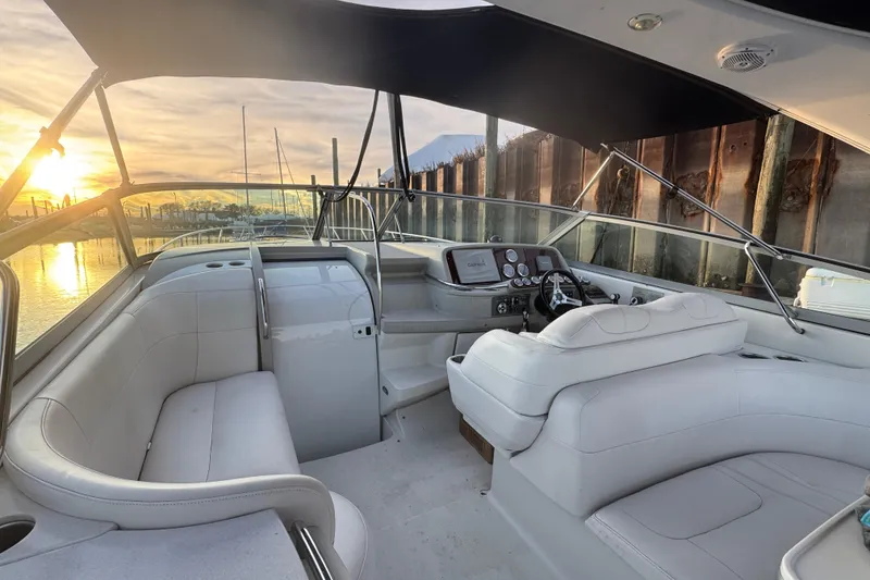 Slide: The Image of 2003 Formula 400 Super Sport boat interior with white seating, steering console, and sunset view. - 4