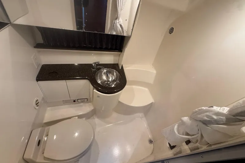 Slide: The Image of 2003 Formula 400 Super Sport bathroom with sink, toilet, and shower area. - 9