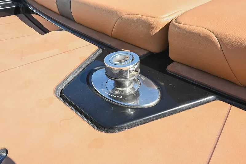 Slide: The Image of 2023 Axis A225 boat interior with tan upholstery and chrome hardware detail. - 14