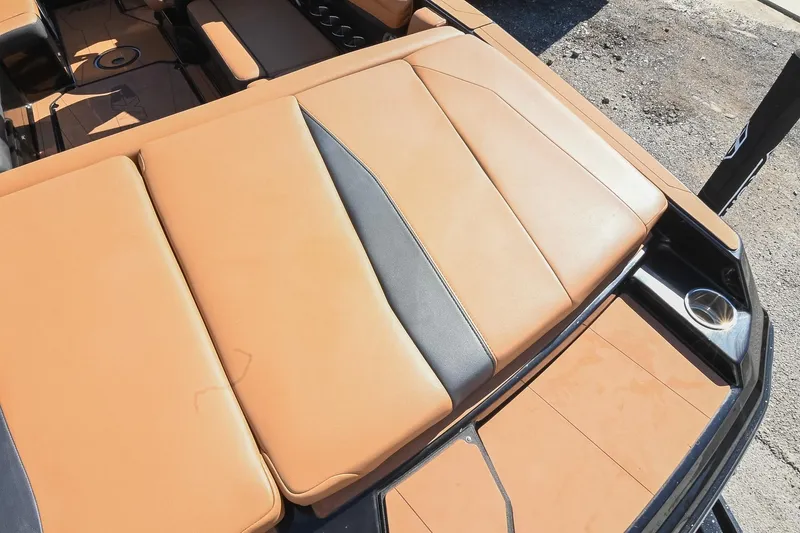 Slide: The Image of 2023 Axis A225 boat interior with tan and black upholstery, showcasing sleek design. - 15