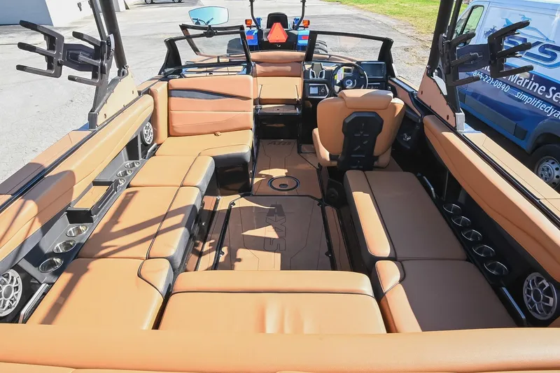 Slide: The Image of 2023 Axis A225 boat interior with tan seating and modern dashboard design. - 17