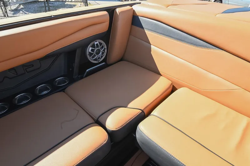 Slide: The Image of 2023 Axis A225 boat interior with tan leather seats and built-in speaker. - 20