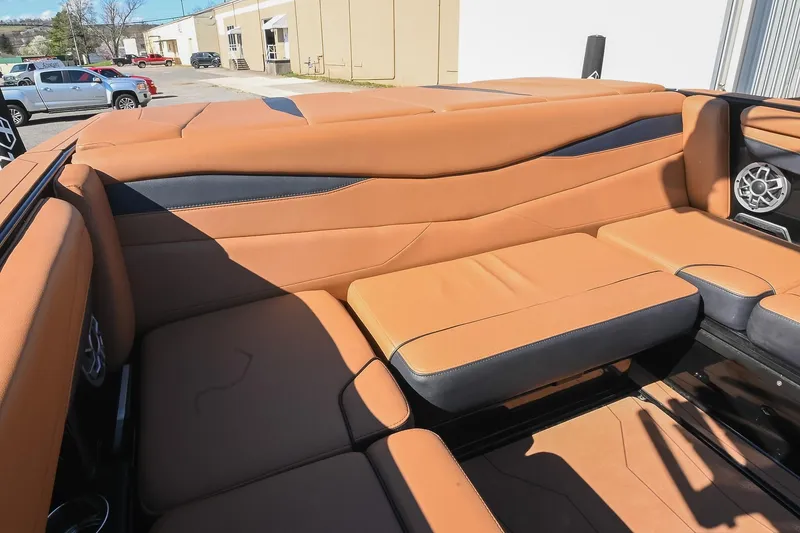 Slide: The Image of 2023 Axis A225 boat interior with tan leather seating and speaker system. - 21