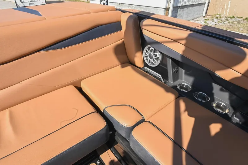 Slide: The Image of 2023 Axis A225 boat interior with tan leather seats and built-in speakers. - 22