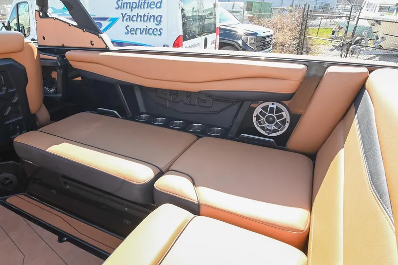 Slide: The Image of 2023 Axis A225 boat interior with tan seating and speaker system. - 23