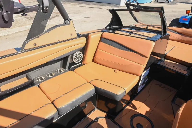 Slide: The Image of 2023 Axis A225 boat interior with tan leather seats and cup holders. - 26